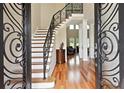Grand foyer with soaring ceilings, hardwood floors, an ornate staircase, and views into the formal living areas at 2548 Westchester Se Way, Conyers, GA 30013