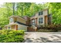 Elegant two-story home featuring brick and stucco with a lush landscaped front yard at 815 Marshview Close, Roswell, GA 30076