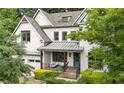 Beautiful two-story brick home boasting a welcoming front porch and meticulously maintained landscaping at 2460 Drew Valley Ne Rd, Brookhaven, GA 30319