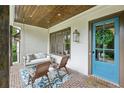 Inviting front porch with a porch swing, stylish decor, and a bright blue front door at 2460 Drew Valley Ne Rd, Brookhaven, GA 30319