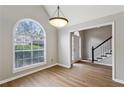 Charming dining room featuring hardwood floors, a vaulted ceiling, and large arched window at 4710 Vineyard Se Ct, Smyrna, GA 30082