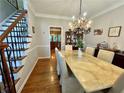 Dining room with wood floors, chandelier, and marble table at 703 Overlook Point, Woodstock, GA 30189