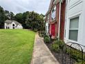 Charming two-story home with landscaped yard and welcoming red front door at 703 Overlook Point, Woodstock, GA 30189