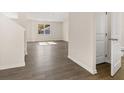 Spacious living room with beautiful wood flooring and natural light at 8225 Coldstream Dr, Fairburn, GA 30213