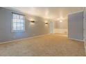 Bright living room featuring neutral carpet, large windows, and ample space at 115 Plantation Dr, Clarkston, GA 30021