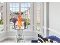 Bright bay window featuring neighborhood views, a modern glass table and a decorative floral arrangement at 1286 Creekside Se Ter, Smyrna, GA 30082