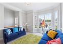 Living room with bay window, two blue sofas, green rug, and contemporary decor at 1286 Creekside Se Ter, Smyrna, GA 30082