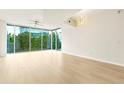 Bright living room with large windows, hardwood floors and modern ceiling fan and light fixture at 3300 Windy Ridge Se Pkwy # 809, Atlanta, GA 30339