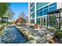 Exterior water feature by building featuring rock waterfall and patio with chairs and trees at 3300 Windy Ridge Se Pkwy # 809, Atlanta, GA 30339