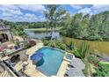 Breathtaking view of the pool, spa, and lake; a perfect setting for relaxation and entertainment at 4745 Cuyahoga Cv, Suwanee, GA 30024