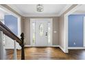 Inviting foyer with hardwood floors, decorative door, and beautiful trim details at 2108 Yorkshire Ct, Woodstock, GA 30189