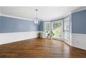 Bright living room with hardwood floors, bay window, and stylish chandelier lighting at 2108 Yorkshire Ct, Woodstock, GA 30189