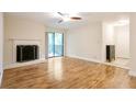 Well-lit living room with a fireplace, balcony entrance, and a spacious feel for modern living at 408 River Run Dr, Sandy Springs, GA 30350