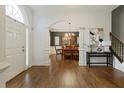 Elegant foyer with hardwood floors, arched doorway, and views into the formal dining room at 610 Woodstream Ct, Roswell, GA 30075