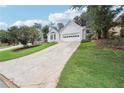 Beautiful home with white painted brick, a two car garage, and an expansive driveway at 645 Ruxbury Ct, Suwanee, GA 30024