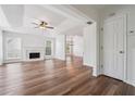 Bright living room with white walls, wood floors, fireplace and lots of natural light at 645 Ruxbury Ct, Suwanee, GA 30024