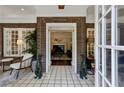 Elegant foyer featuring brick walls, tiled flooring, and an open view into the living room at 16 Walker Ne Ter, Atlanta, GA 30309