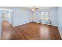 This living room offers wood-look flooring, a ceiling fan, light-filled room at 6516 Maddox Rd, Morrow, GA 30260