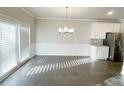 Dining area with modern chandelier, wainscoting, and access to the backyard at 2314 Shetley Creek Dr, Norcross, GA 30071