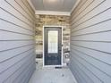 Entryway featuring stone accents and modern door with glass panel at 2314 Shetley Creek Dr, Norcross, GA 30071