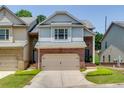 Charming brick and siding townhome with a two-car garage and well-maintained lawn at 2968 Oshields Sw Ct # 4, Marietta, GA 30060