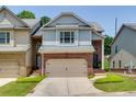 Beautiful townhome featuring a brick front, gray siding, and a convenient two-car garage at 2968 Oshields Sw Ct # 4, Marietta, GA 30060