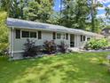 Lovely single-story home featuring gray siding, shutters, and lush front yard at 1467 Hewatt Rd, Lilburn, GA 30047