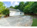 Spacious two-car garage and driveway surrounded by mature trees at 7610 Golden Sands Dr, Cumming, GA 30041