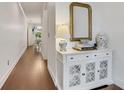 Elegant hallway featuring dark wood floors, white console table, and decorative mirror at 146 Bellehaven Dr, Woodstock, GA 30188