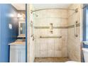 Accessible bathroom featuring tiled walls, a tiled shower, and supportive grab bars for safety at 3556 Riley Rd, Douglasville, GA 30134