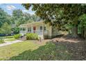 This home has a charming front porch, complemented by a lush, green lawn at 58 Bisbee Se Ave, Atlanta, GA 30315