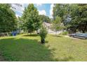 Well-maintained front yard with lush green grass, mature trees, and driveway at 58 Bisbee Se Ave, Atlanta, GA 30315