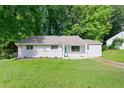 Lovely single-story home with a well-manicured lawn and mature trees in a quiet neighborhood at 1735 Carter Cir, Atlanta, GA 30344