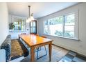 Bright dining area with a large window, banquette seating, a wood table, and a classic pendant light at 570 Park Se Ave, Atlanta, GA 30312