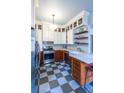 Well-lit kitchen with ample cabinetry, stainless steel appliances, checkerboard floor, and countertop workspace at 570 Park Se Ave, Atlanta, GA 30312