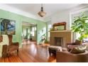 Inviting living room featuring hardwood floors, a brick fireplace, and plenty of natural light at 570 Park Se Ave, Atlanta, GA 30312