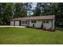 Ranch style home with a well maintained lawn and updated facade at 905 Hickory Ridge Sw Rd, Lilburn, GA 30047