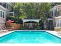 Outdoor pool featuring lounge chairs, umbrellas and shaded seating areas at 2232 Dunseath Nw Ave # 309, Atlanta, GA 30318