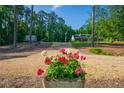 Charming home with a long driveway, vibrant flowers, and picturesque curb appeal at 1382 Varner Rd, Marietta, GA 30062