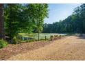 Driveway view of serene pond featuring planters, adding a touch of nature to the property at 1382 Varner Rd, Marietta, GA 30062
