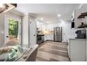 Bright kitchen featuring stainless steel appliances and white cabinetry and hardwood flooring at 1575 Barrier Rd, Marietta, GA 30066