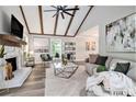 Open-concept living room with modern decor, stone fireplace and hardwood flooring at 1575 Barrier Rd, Marietta, GA 30066