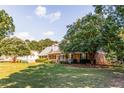 Charming brick home surrounded by lush greenery and a spacious lawn at 184 Wildflower Dr, Social Circle, GA 30025