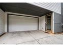 Attached one car garage, sealed concrete driveway, and covered entry to modern house at 76 Mayson Avenue Northeast Ne, Atlanta, GA 30307