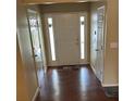 Bright entryway featuring hardwood floors and a white front door flanked by sidelights at 2256 Hansford Pass, Buford, GA 30519