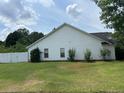 Side exterior view of home with white siding and a well-maintained lawn at 2256 Hansford Pass, Buford, GA 30519