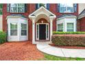 Inviting front entrance with a black door, white pillars, and manicured landscaping at 3065 Moser Way, Marietta, GA 30060