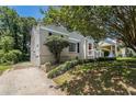 A house on a lot with manicured lawn, side view, and a bright red front door at 1932 Neely Ave, Atlanta, GA 30344