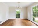 Bright dining room with hardwood floors, large windows, and modern chandelier at 59 Oakmont Nw Dr, Marietta, GA 30064
