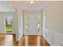 Light and airy foyer with hardwood floors, paneled walls, and sidelights flanking the front door at 59 Oakmont Nw Dr, Marietta, GA 30064
